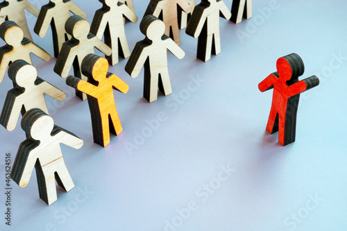 Talent recruitment concept. Crowd of figures and figurines with a raised hand.