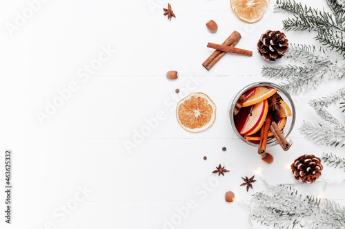 Christmas banner flat lay with glass cup of Mulled Wine, gift box, decorations