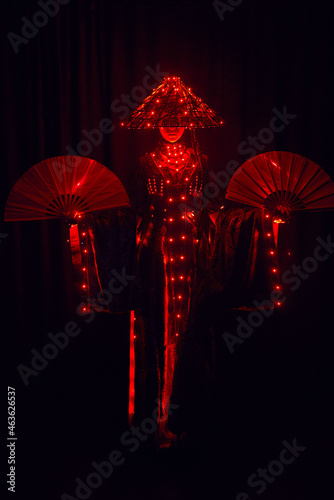 Faceless woman in authentic costume with hat and glowing lights