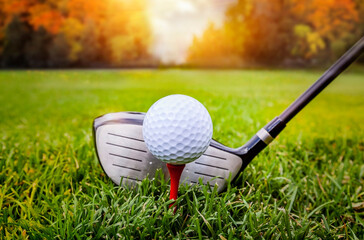 Golf ball and golf club in beautiful golf course at sunset background