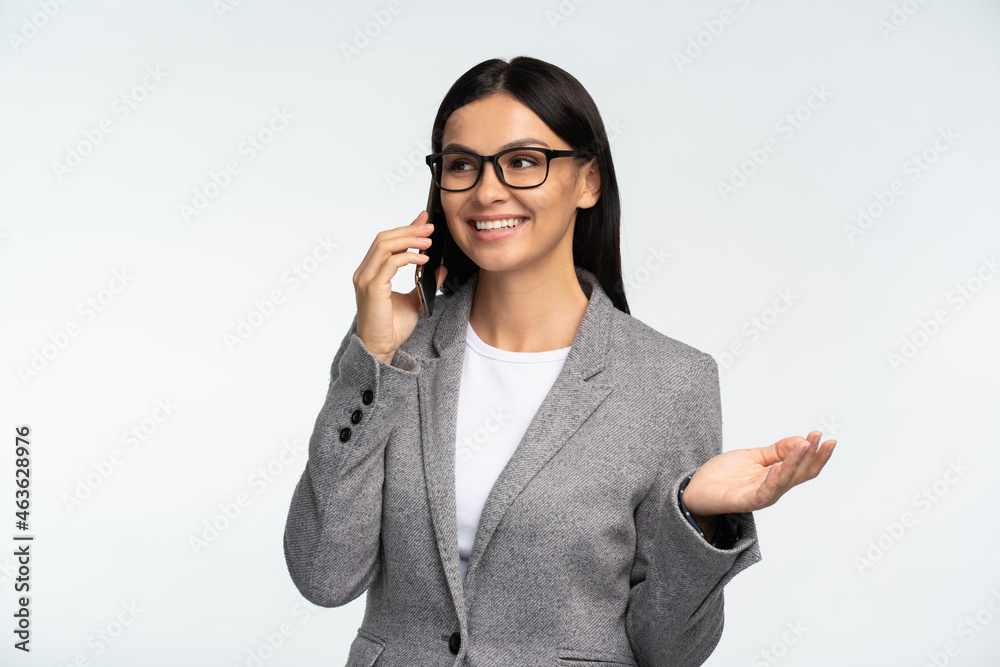 Portrait of cheerful business lady in formal suit using mobile phone, making call and talking with business partners. Connection concept