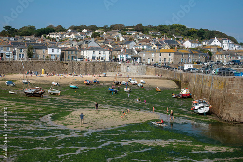Mousehole, Cornwall, England, UK. 2021.  Mousehole a popular Cornish holiday and fishing resort in southern Cornwall at low tide. photo