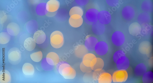 Abstract background with orange and purple bokeh on an azure backdrop. Defocused. Blurred.