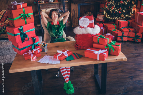 Photo of relaxed carefree worker lady sit armchair sleepy mood wear elf costume in decorated office indoors
