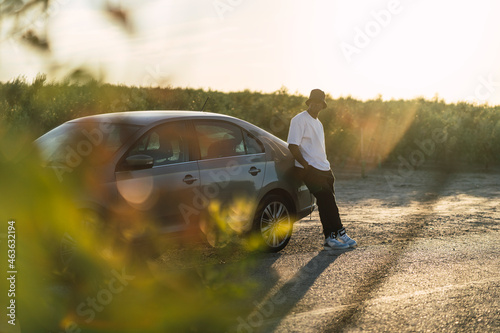 Chico negro atletico con camiseta blanca en carretera abandonada  photo