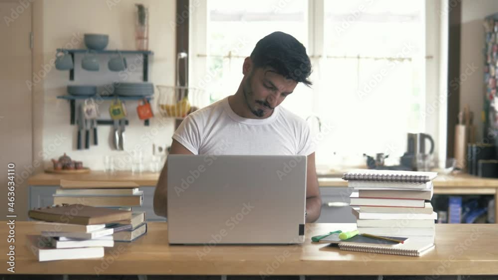 Handsome hispanic guy using laptop in modern interior space. Smiling focused man receiving message on computer indoors. Young latin businessman chatting, writing essay, prepare documents Handsome hispanic guy using laptop in modern interior space. Smiling focused man receiving message on computer indoors. Young latin businessman chatting, writing essay, prepare documents