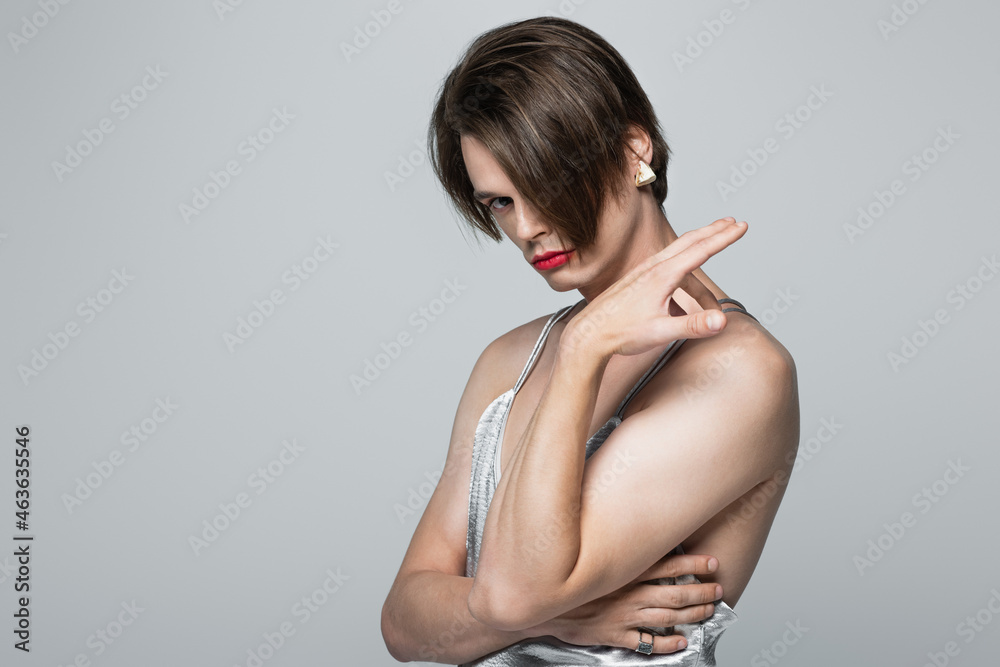 Φωτογραφία transgender person with red lips and earring posing in slip dress isolated on gr