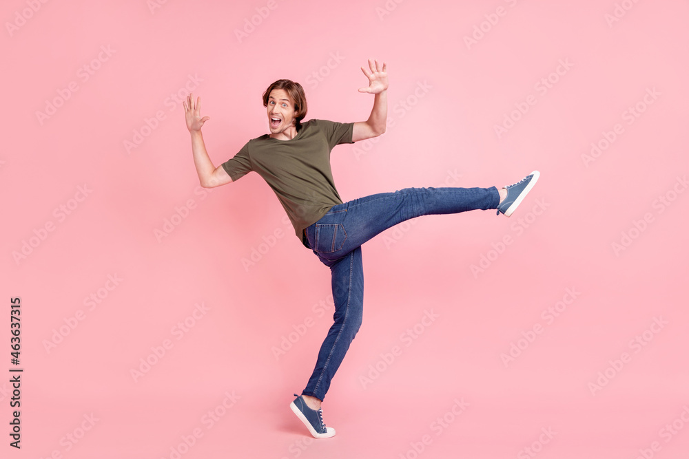 Full body profile side photo of young guy happy positive smile fooling go step isolated over pink color background Full body profile side photo of young guy happy positive smile fooling go step isolated over pink color background
