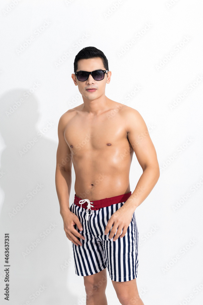 Man in striped beach shorts sunbathing.