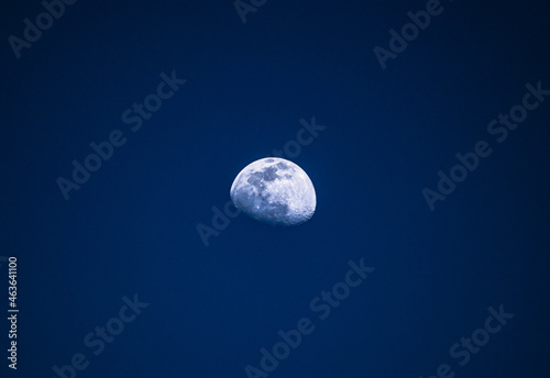 partial moon in night sky with minimalistic view alone in background