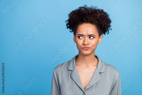 Photo of young beautiful african girl displeased look empty space bad dream isolated over blue color background