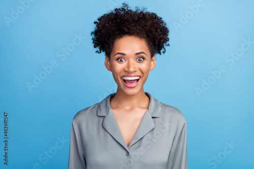 Photo of young excited african girl unexpected good news sleepover isolated over blue color background
