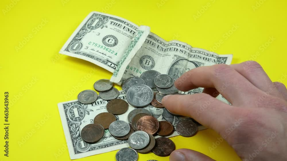Man takes American one dollar and cents. Inflation rate. Economic crisis. Сurrency devaluation. Business concept. Close up, soft focus. Man takes American one dollar and cents. Inflation rate. Economic crisis. Сurrency devaluation. Business concept. Close up, soft focus.
