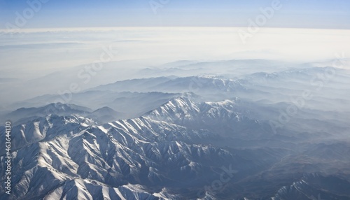Snowy mountain ridge above the haze