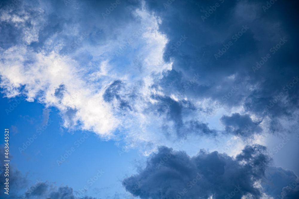 sun highlighting storm clouds with a blue sky looking directly up sun highlighting storm clouds with a blue sky looking directly up