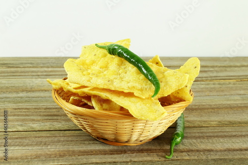 traditional indian gujarati snack food fafda with chilli in bamboo basket  photo