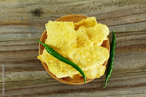 traditional indian gujarati snack food fafda with chilli in bamboo basket top view photo
