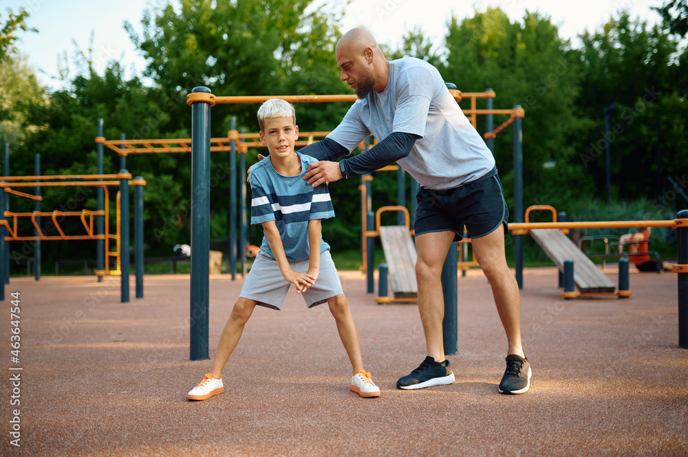 Father and son, sport training on playground