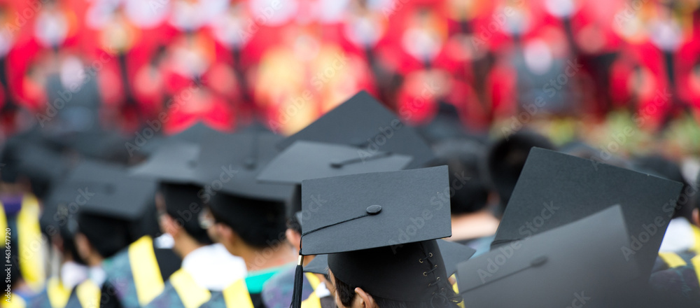 back of graduates during commencement. back of graduates during commencement.