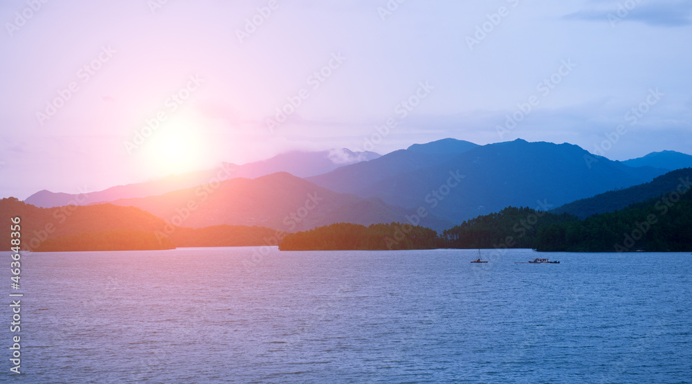 Fototapeta premium The mountains surround lake with light fog.