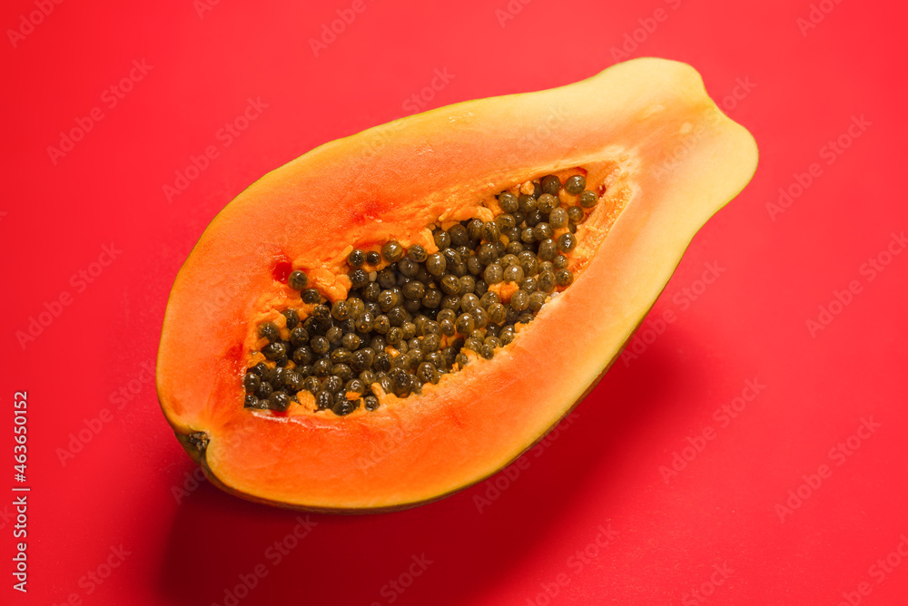 Papaya fruit on a orange background. Half papaya. Papaya fruit on a orange background. Half papaya.