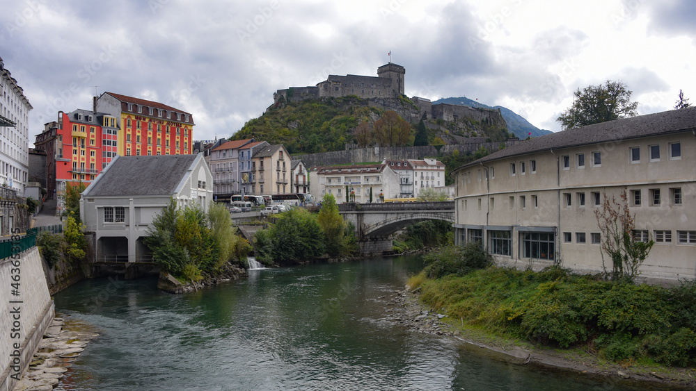 Lourdes, France - 9 Oct, 2021: Views along the River Ousse towards Lourdes Castle and Pyrenees Museum Lourdes, France - 9 Oct, 2021: Views along the River Ousse towards Lourdes Castle and Pyrenees Museum