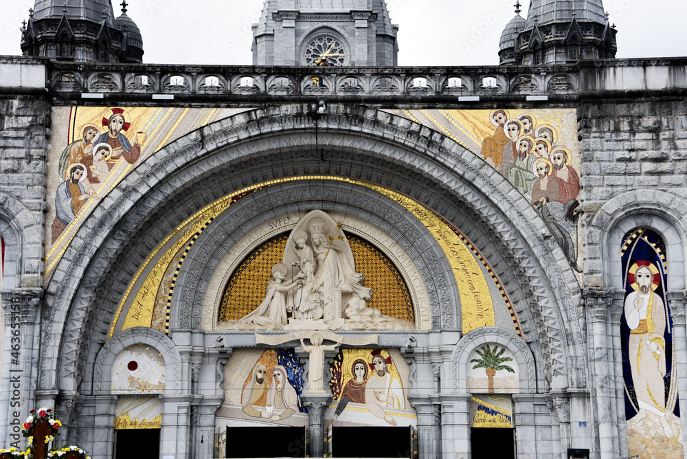Lourdes, France - 9 Oct, 2021: Religious artwork and mosaics at the entrance to the Sanctuary de Notre Dame Cathedral, Lourdes