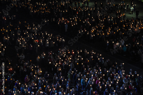 Lourdes, France - 9 Oct 2021: Pilgrims attend the Marian Torchlight Procession service at the Rosary Basilica in Lourdes