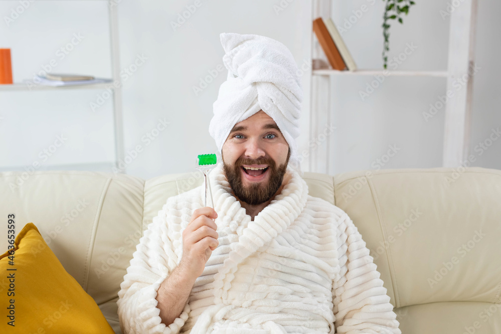 Funny man with facial massage tool. Male skin care and spa concept. Funny man with facial massage tool. Male skin care and spa concept.