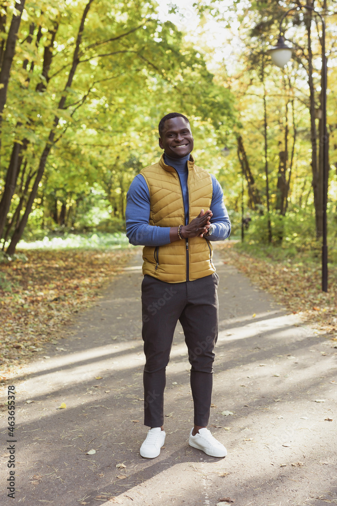 African american student walking in the park in autumn season African american student walking in the park in autumn season