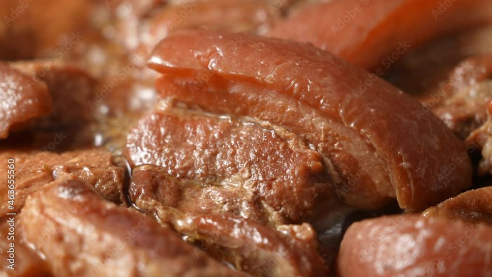 Cooking traditional Taiwanese braised pork belly, close up of stewed pork chop.
Cooking traditional Taiwanese braised pork belly, close up of stewed pork chop.