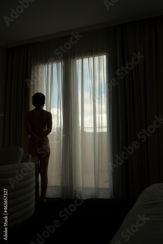 Woman alone hotel bedroom