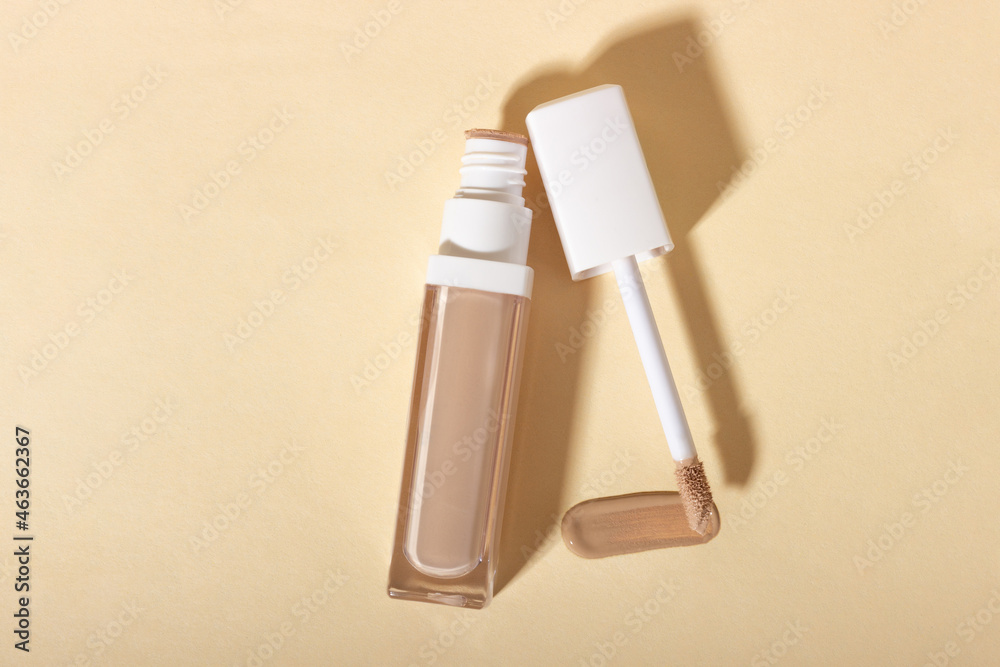 Concealer cream on a background with shadows. Face corrector on beige background with copy space. Blank mockup for product Concealer cream on a background with shadows. Face corrector on beige background with copy space. Blank mockup for product