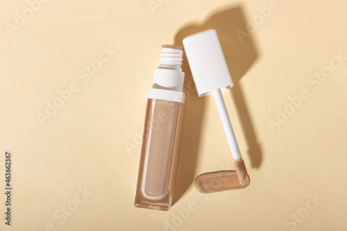 Concealer cream on a background with shadows. Face corrector on beige background with copy space. Blank mockup for product