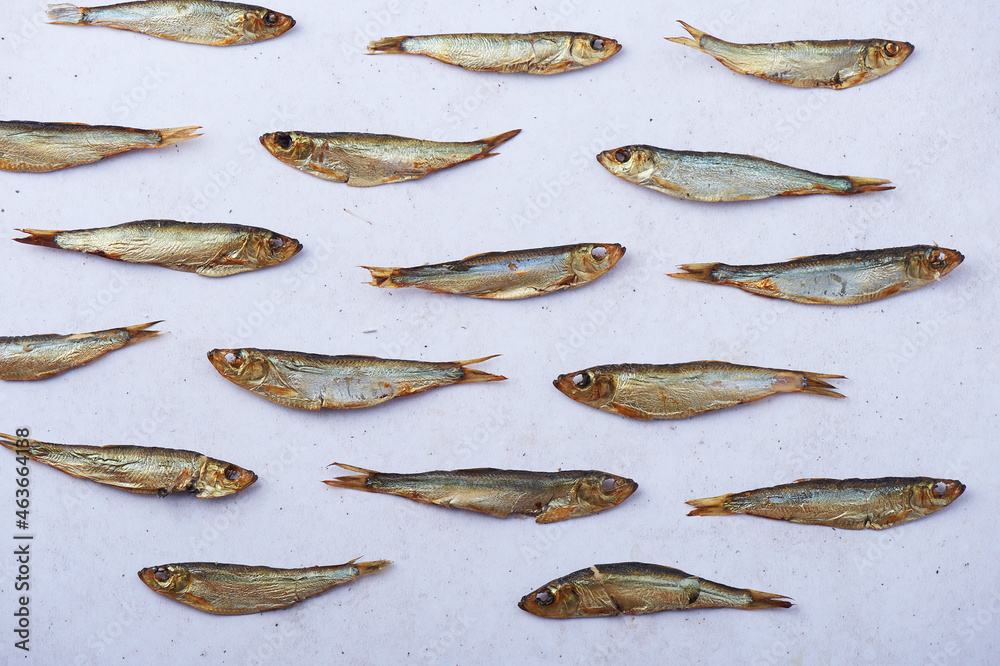 Smoked european sprats over white background Smoked european sprats over white background