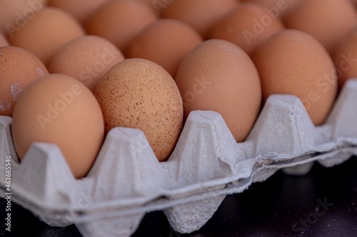 Selective focus of chicken eggs in the tray for sale in the market stall, Eggs in brown paper panels in the kitchen for cooking.