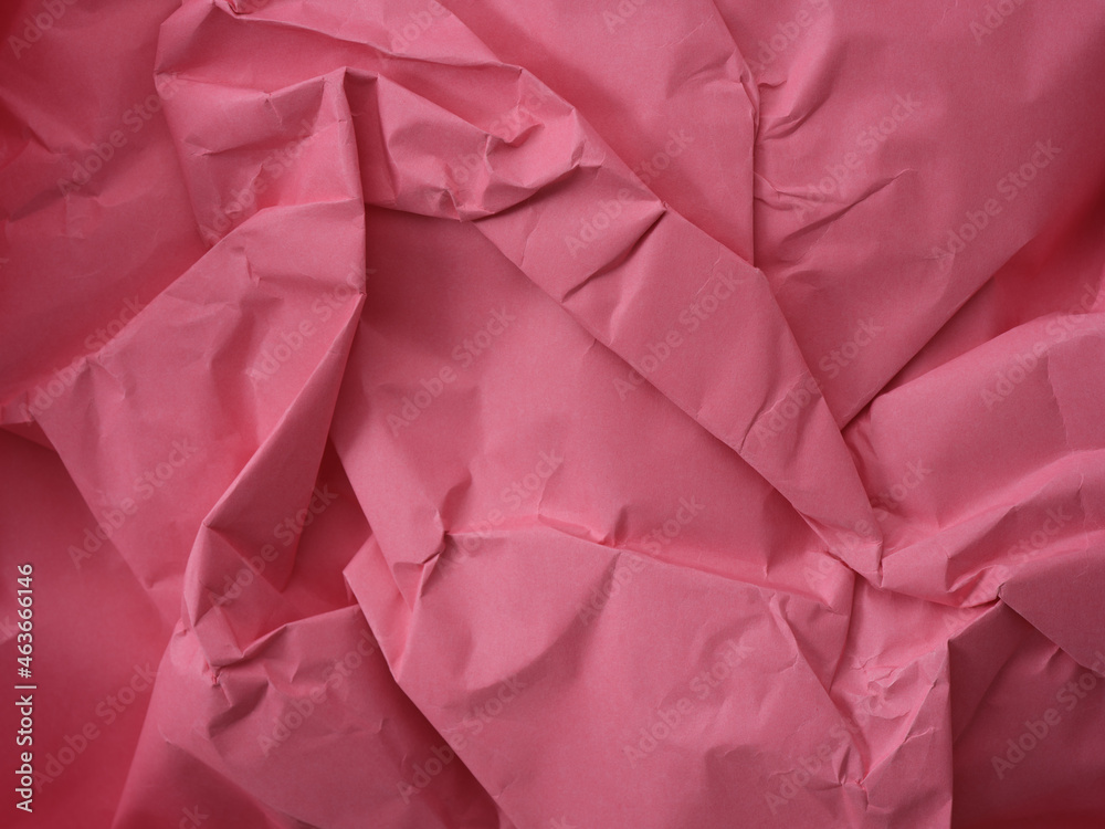 A crumpled pink paper background A crumpled pink paper background