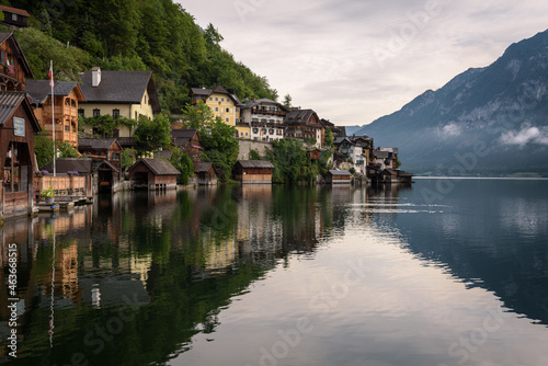 Panoramic view of famous old town Hallstatt and alpine deep blue lake in scenic sunrise light on a beautiful day in summer, Salzkammergut, Austria