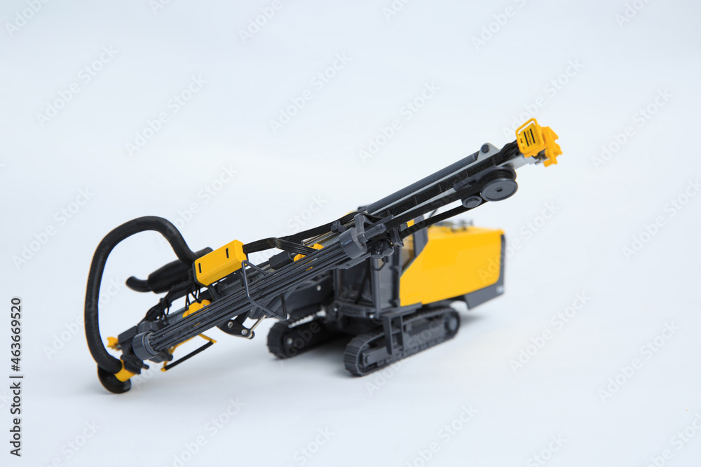 Natural scale model of a contour drill rig on a white background