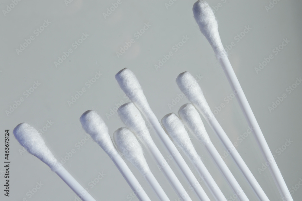 Heap of cotton swabs on a white background, hygienic cosmetic an Heap of cotton swabs on a white background, hygienic cosmetic an