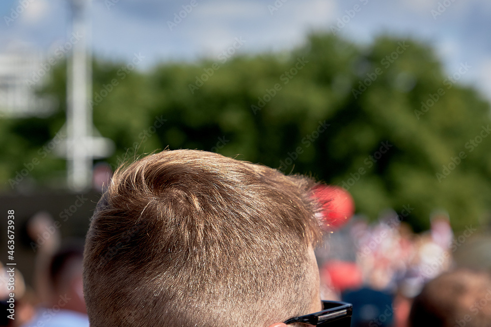 A man with glasses standing in front of a crowd during a demonstration A man with glasses standing in front of a crowd during a demonstration
