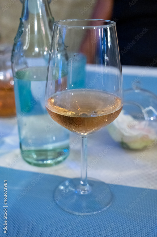 Obraz premium Summer on French Riviera Cote d'Azur, drinking cold rose from Cotes de Provence on outdoor terrase in old cafe, Var, France