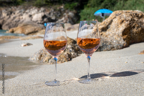 Summer time in Provence, two glasses of cold rose wine on sandy beach near Saint-Tropez, Var department, France