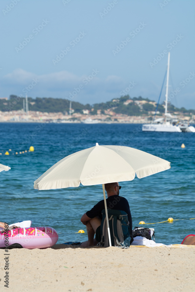 Undentified people sunbathing on sandy beach on French Riviera, Var, France