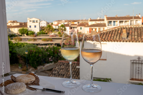 Summer on French Riviera Cote d'Azur, drinking cold rose and white wine from Cotes de Provence on outdoor terrase in Port Grimaud, Var, France © barmalini