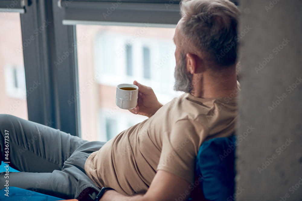 A man habving his morning coffee and looking relaxed A man habving his morning coffee and looking relaxed