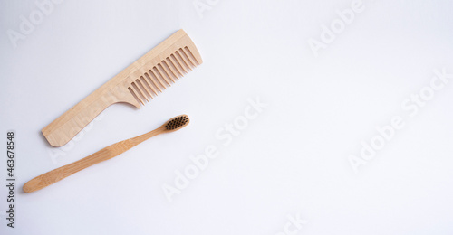 eco brush and toothbrush  made of bamboo and wood on white background