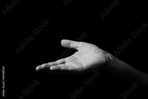Male hand held out, gesturing with palm up.