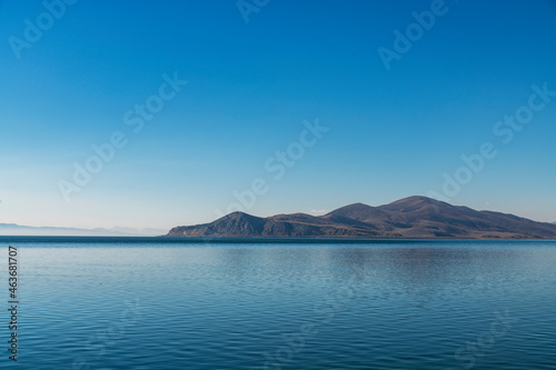 Blue lake and mountains in the sunny day. Beautiful seascape landscape.