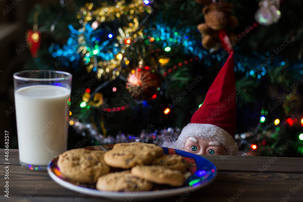 Father Christmas toy watching the cookies and the glass of milk.